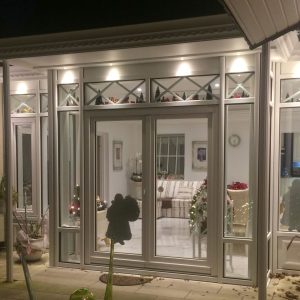 Victorian Wintergarten with flat roof and hipped roof glass dome.