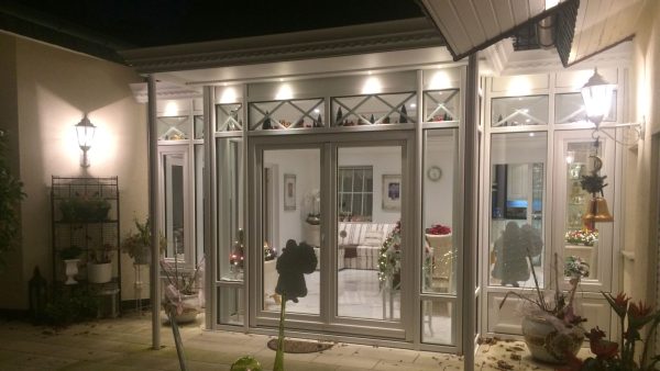 Victorian Wintergarten with flat roof and hipped roof glass dome.